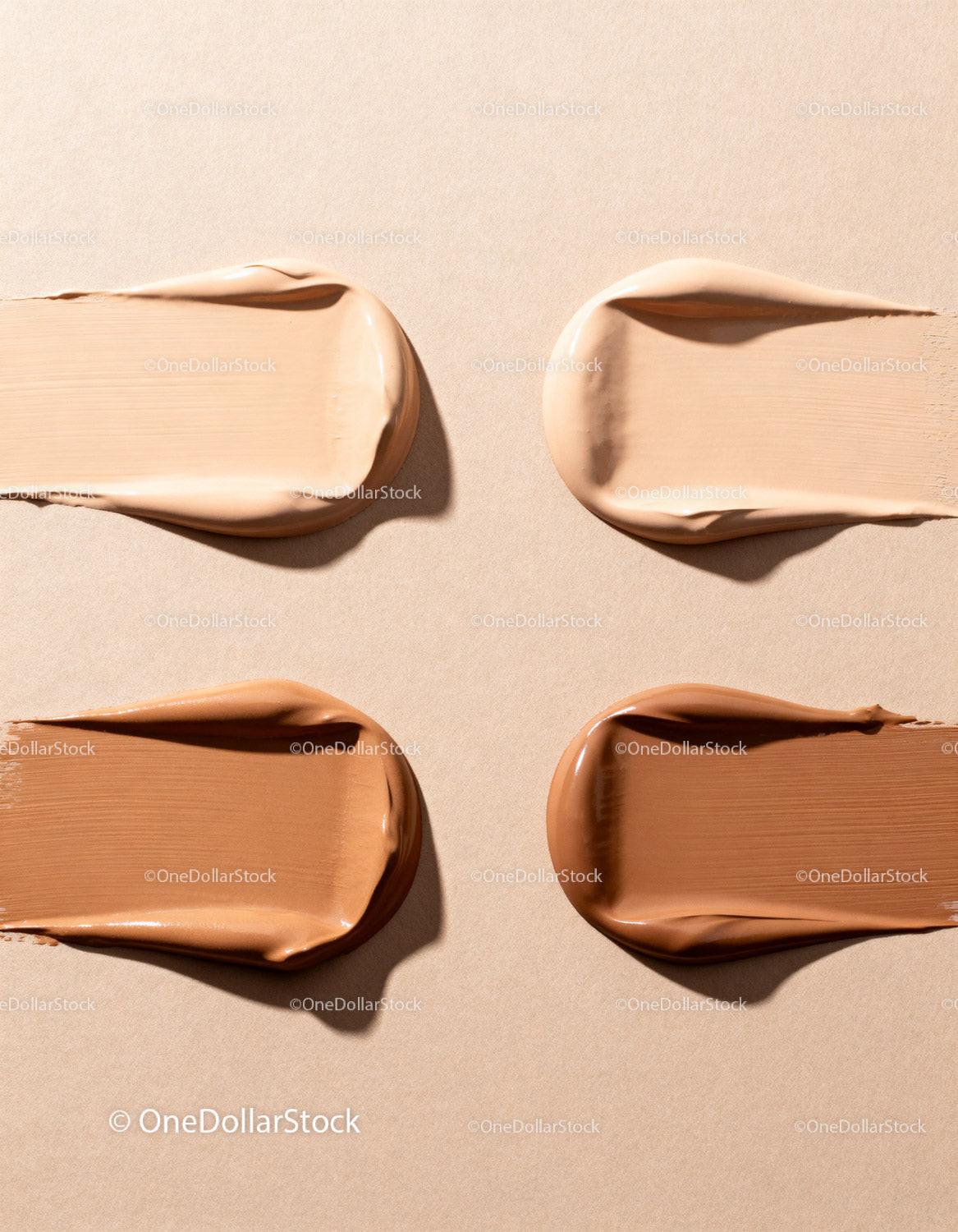 Varied Beige to Brown Foundation Swatches on Neutral Background