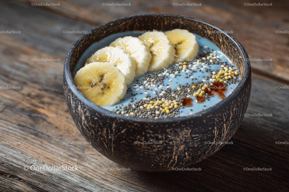 Delicious Smoothie Bowl with Banana and Chia Seeds on Wooden Table