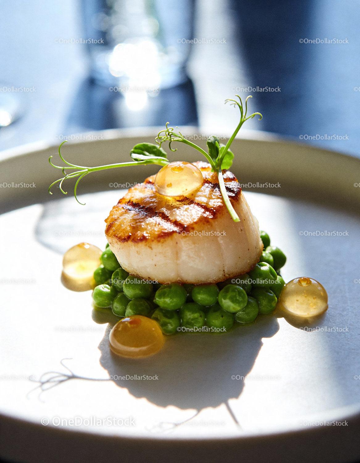Seared Scallop on Fresh Green Peas with Herb Garnish