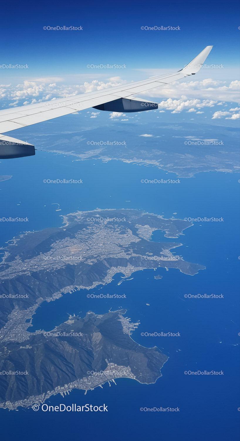 Aerial View of Coastline and Mountains From Airplane Window