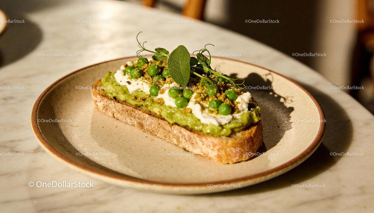 Fresh avocado toast topped with peas and herbs
