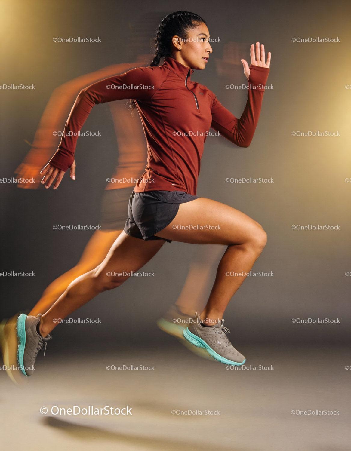 Athletic woman sprinting in dynamic studio light