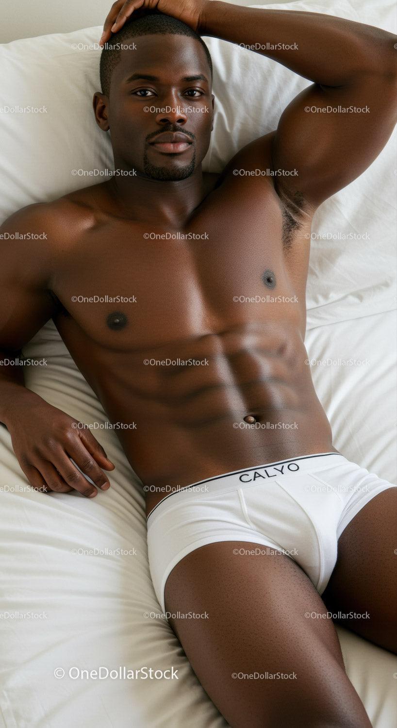 Relaxed man lying on bed in white underwear