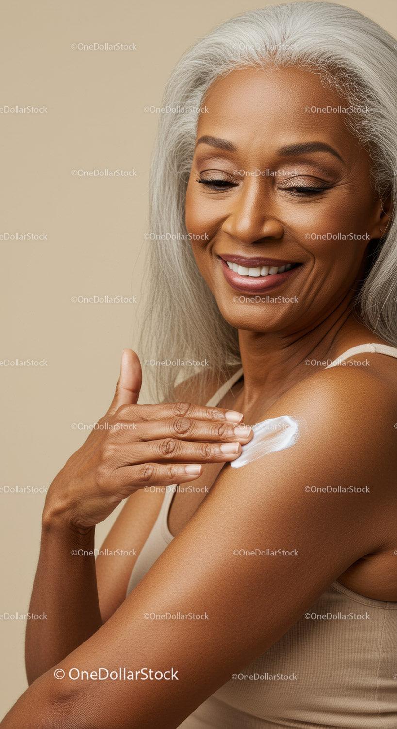 Beautiful Elderly Woman Applying Skincare Lotion with a Radiant Smile