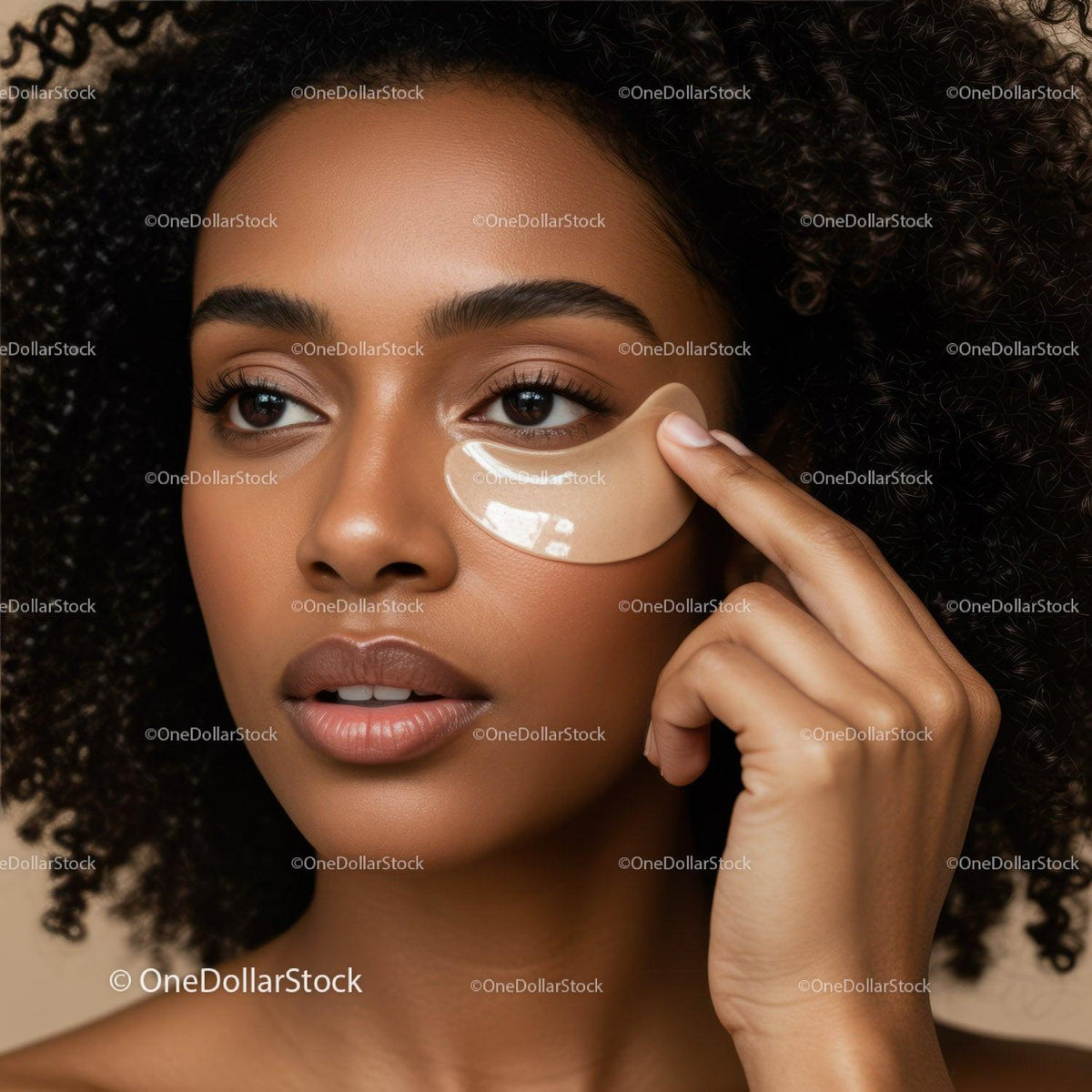 Close-up of a Young Woman with Curly Hair Applying an Eye Patch