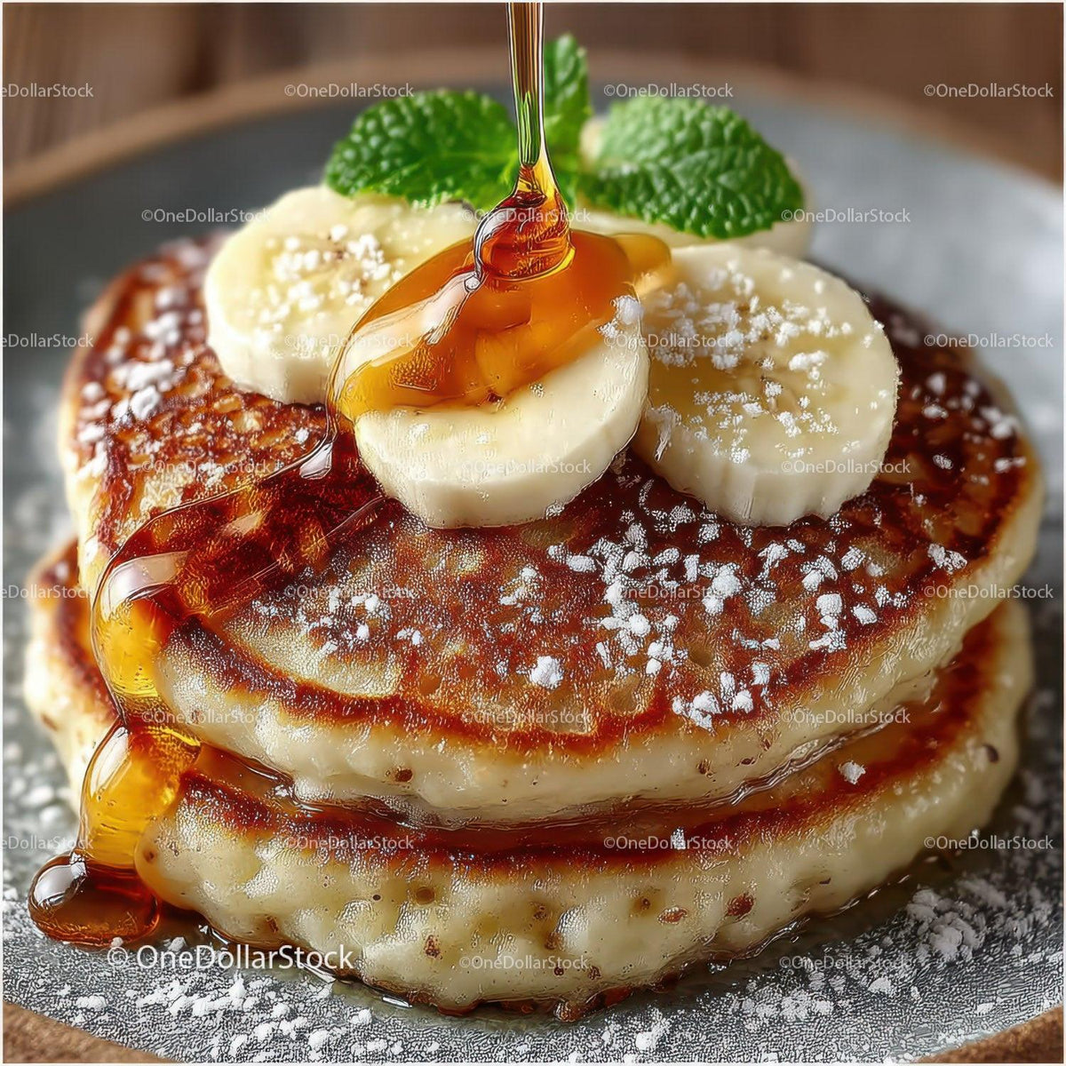 Close-Up of Fluffy Pancakes with Banana Slices and Maple Syrup