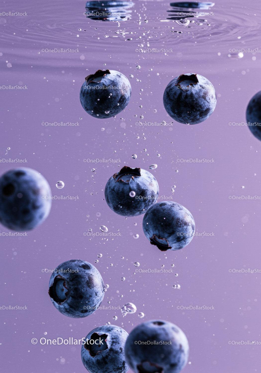 Fresh blueberries submerged in clear water bubbles