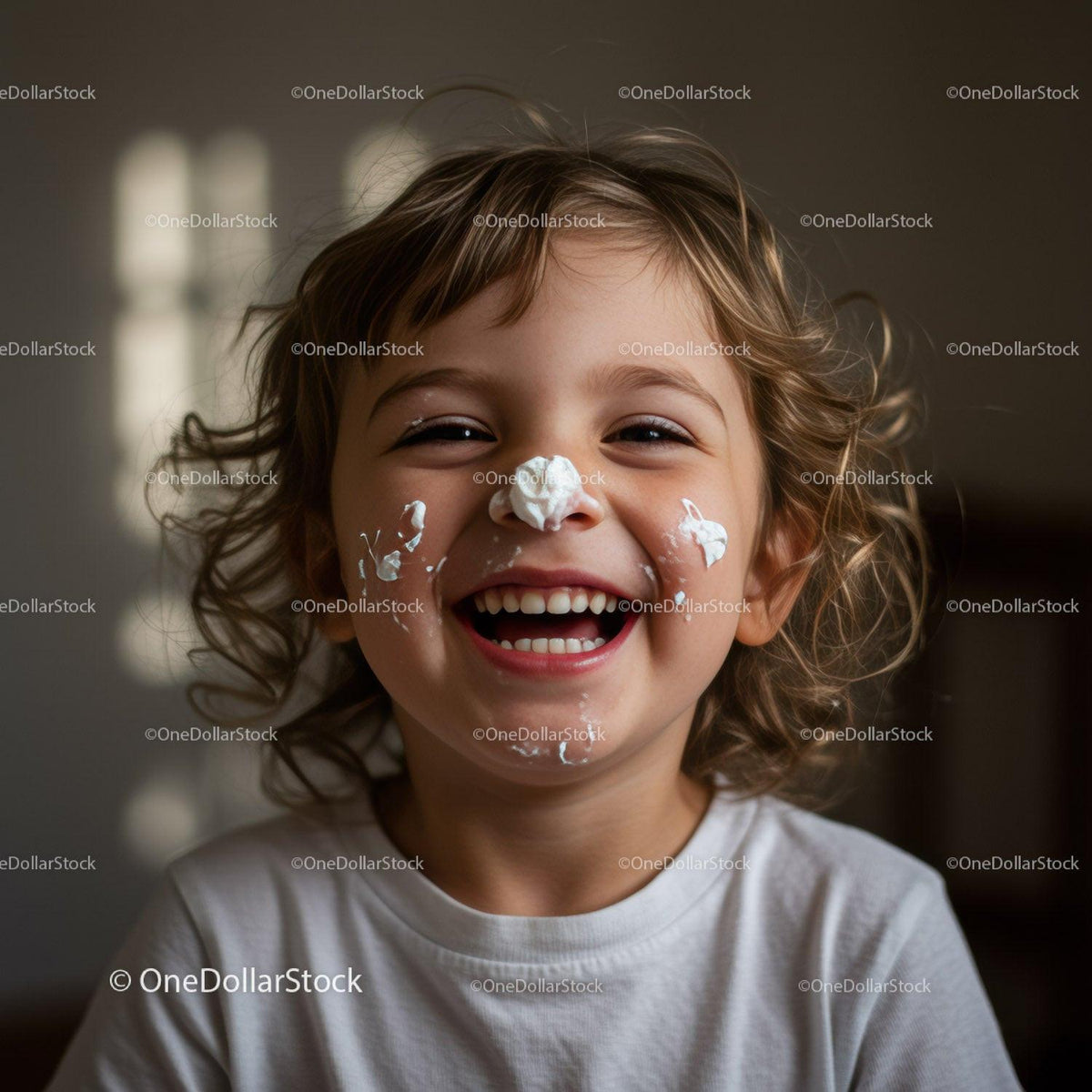 Happy child laughing with whipped cream on face