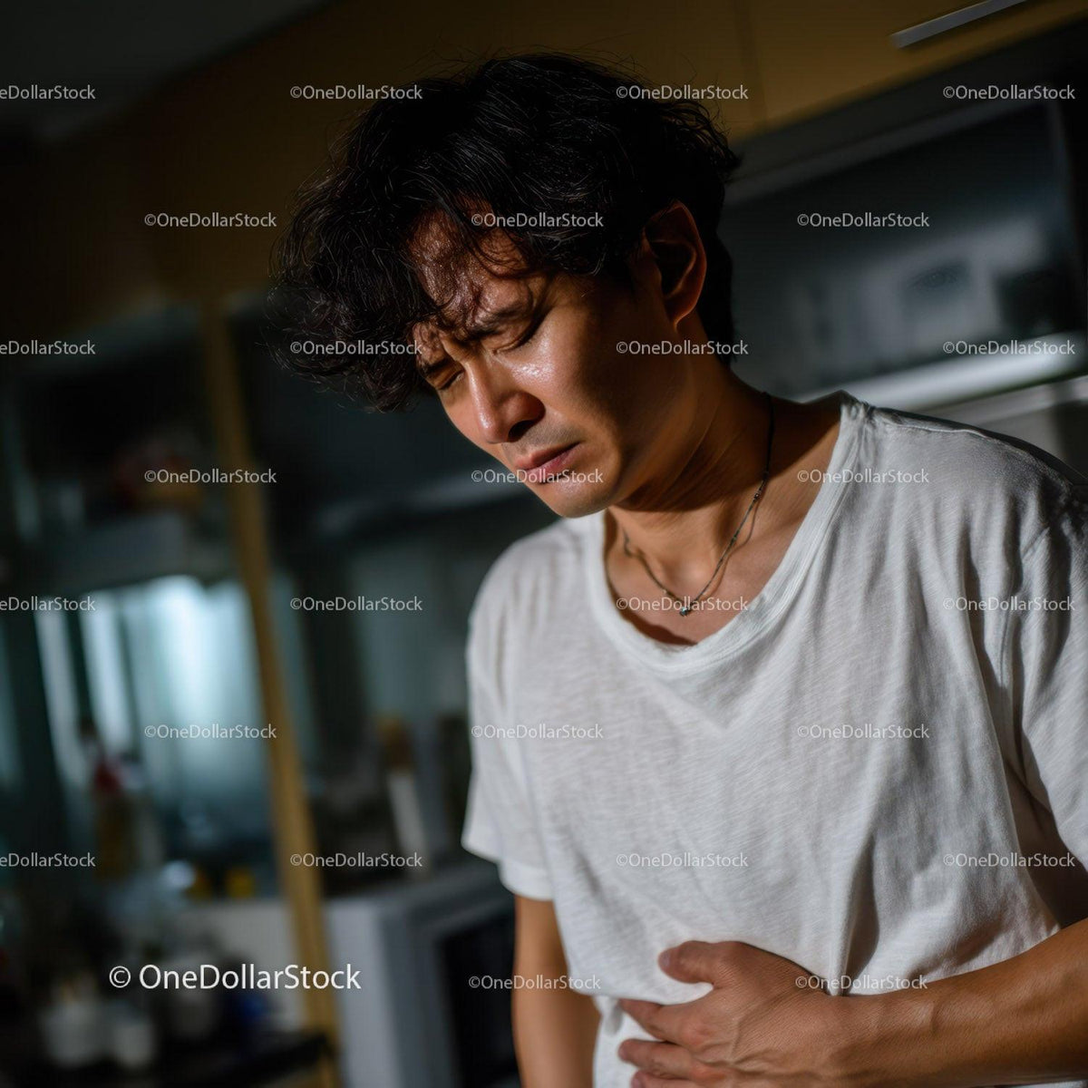 Young Man Experiencing Abdominal Pain and Discomfort