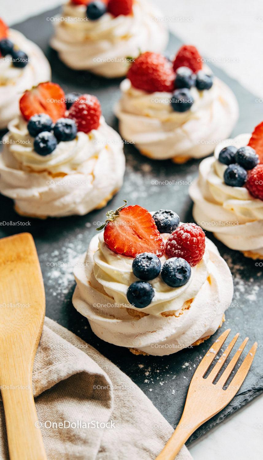Mini Pavlova Desserts with Fresh Berries on Slate Board