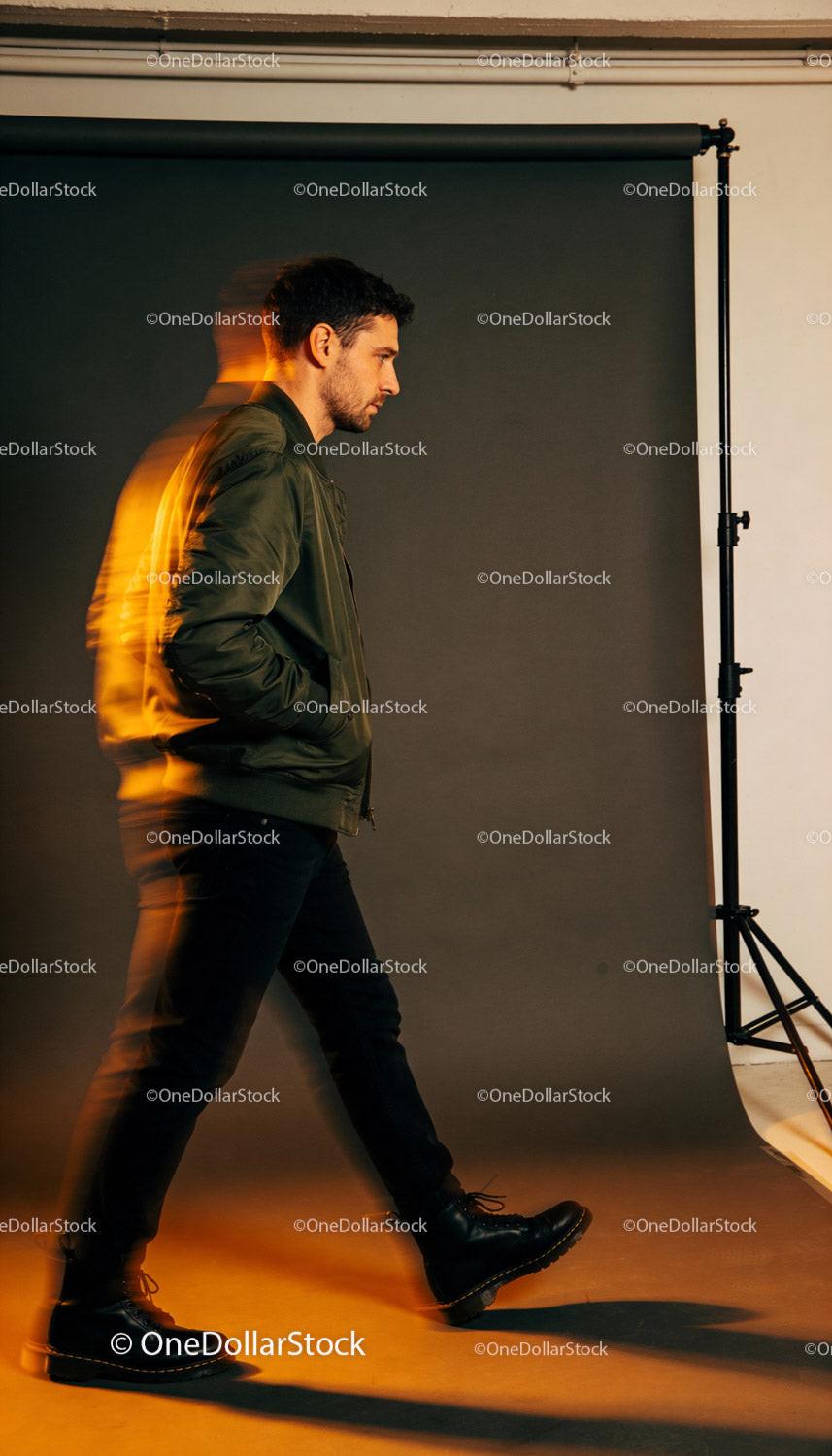 Man in green jacket walking with motion blur effect