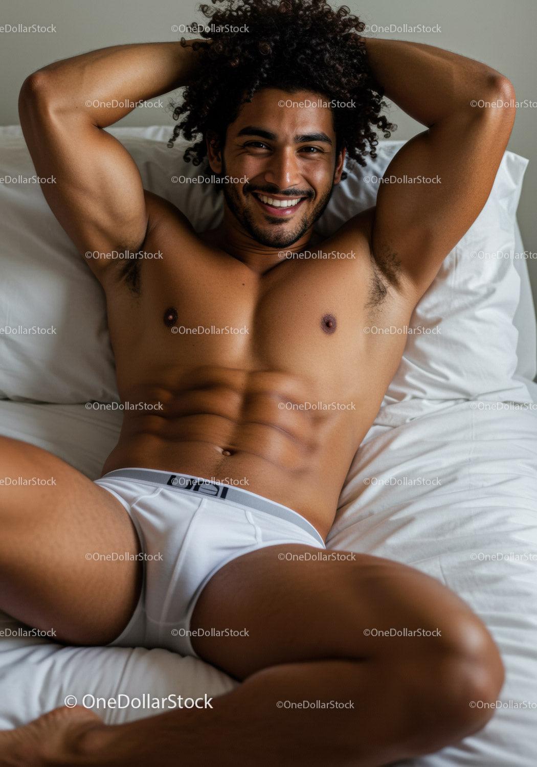 Smiling man relaxing on bed in white underwear