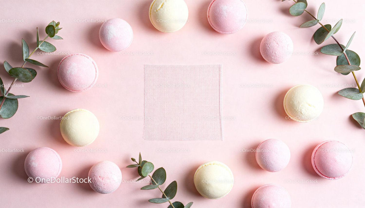 Pastel Macarons and Eucalyptus Branches on Pink Background