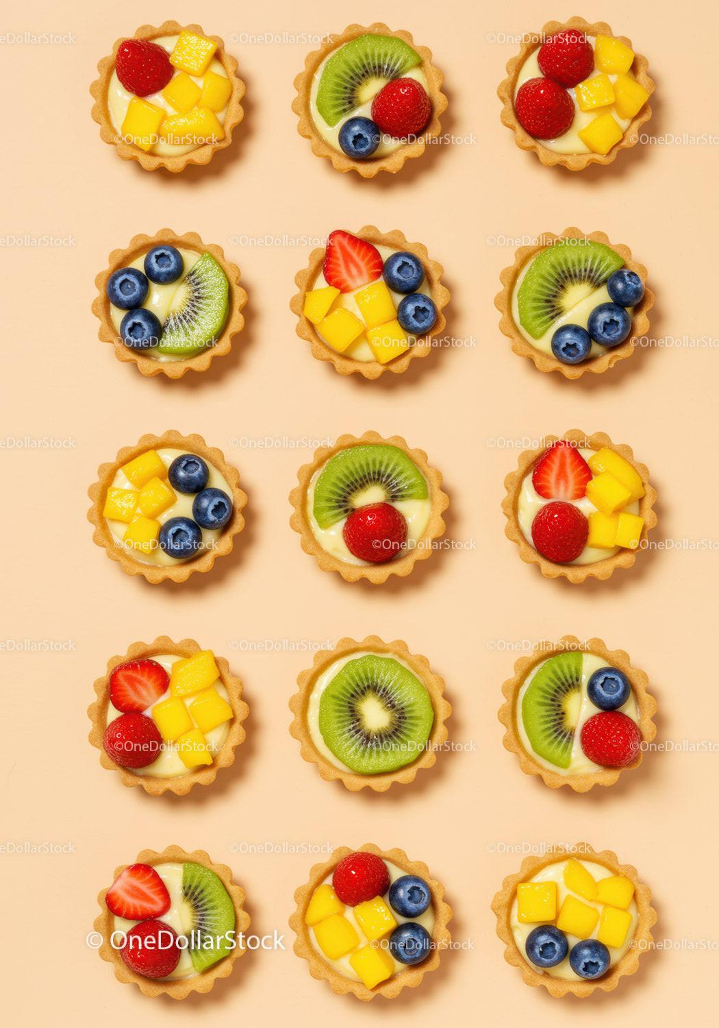 Colorful Mini Fruit Tarts with Cream on Beige Background