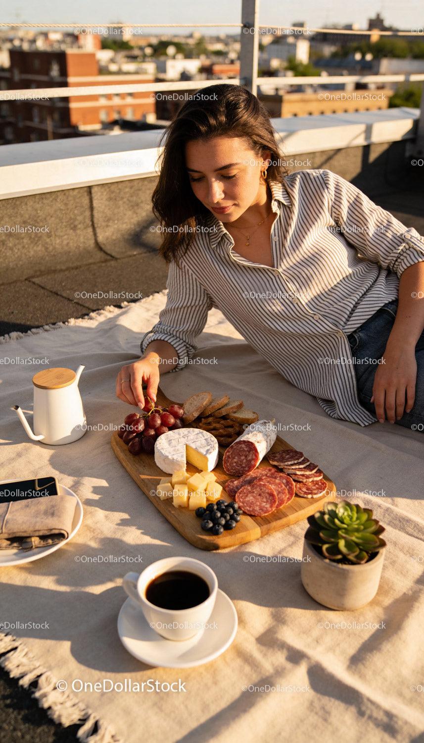 Woman enjoying a relaxed outdoor charcuterie board picnic