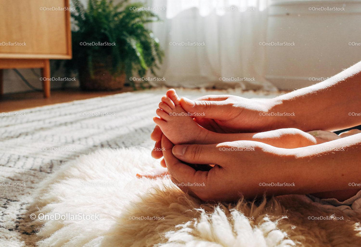 Gentle Touch of Parent Holding Baby Feet Indoors