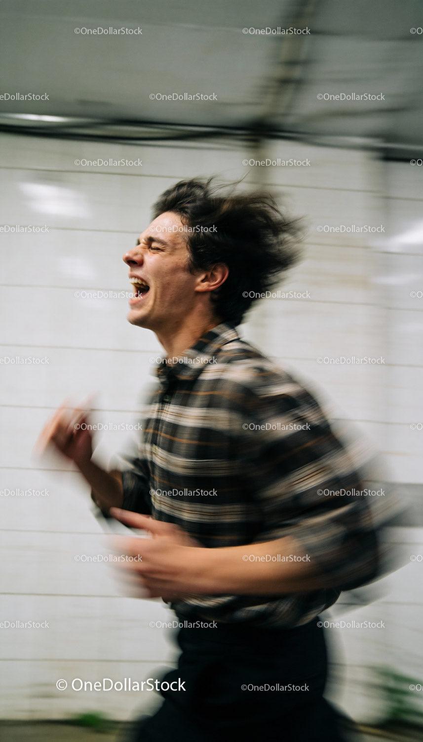 Young man expressing intense emotion in motion blur