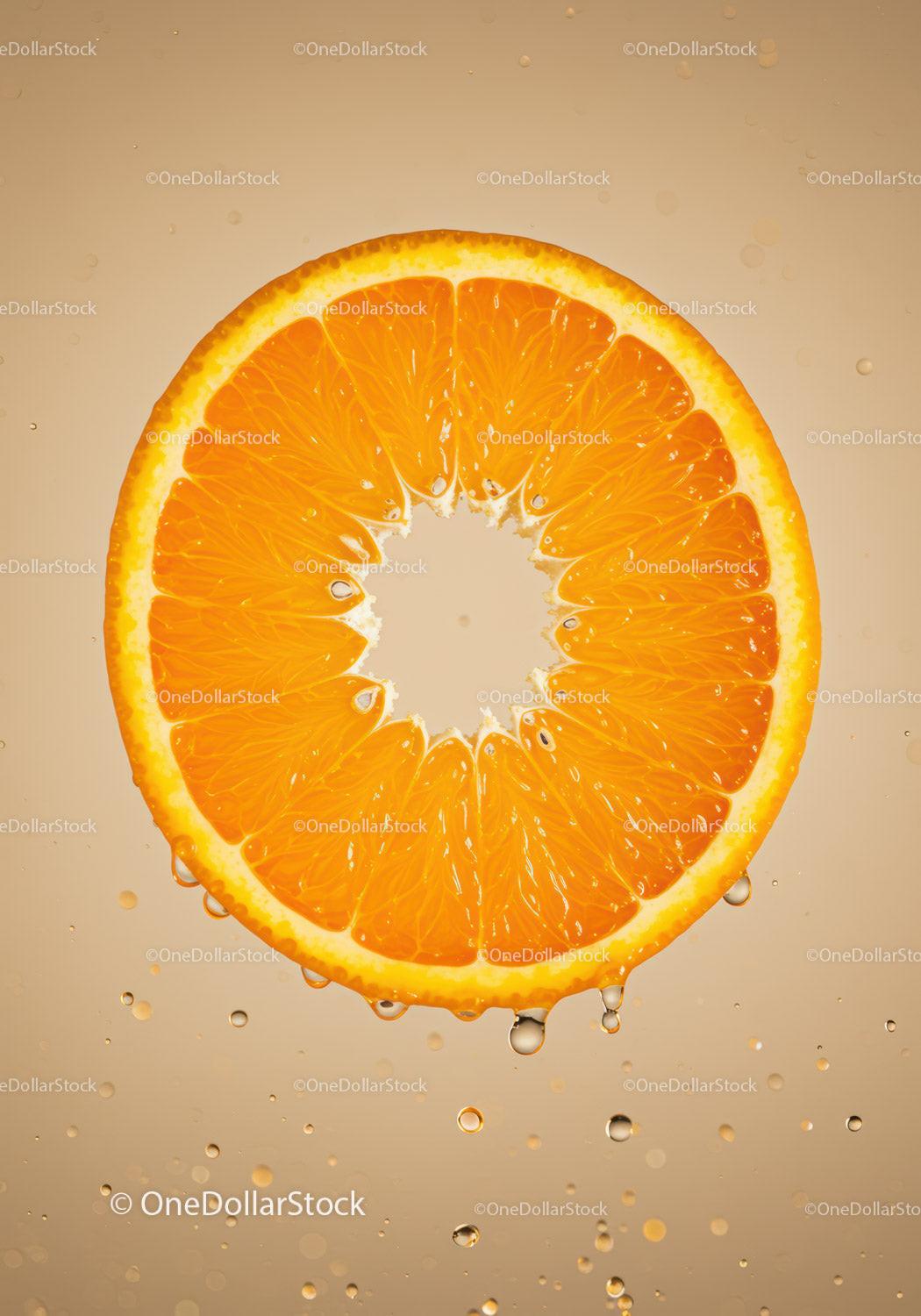 Fresh orange slice suspended in water with bubbles