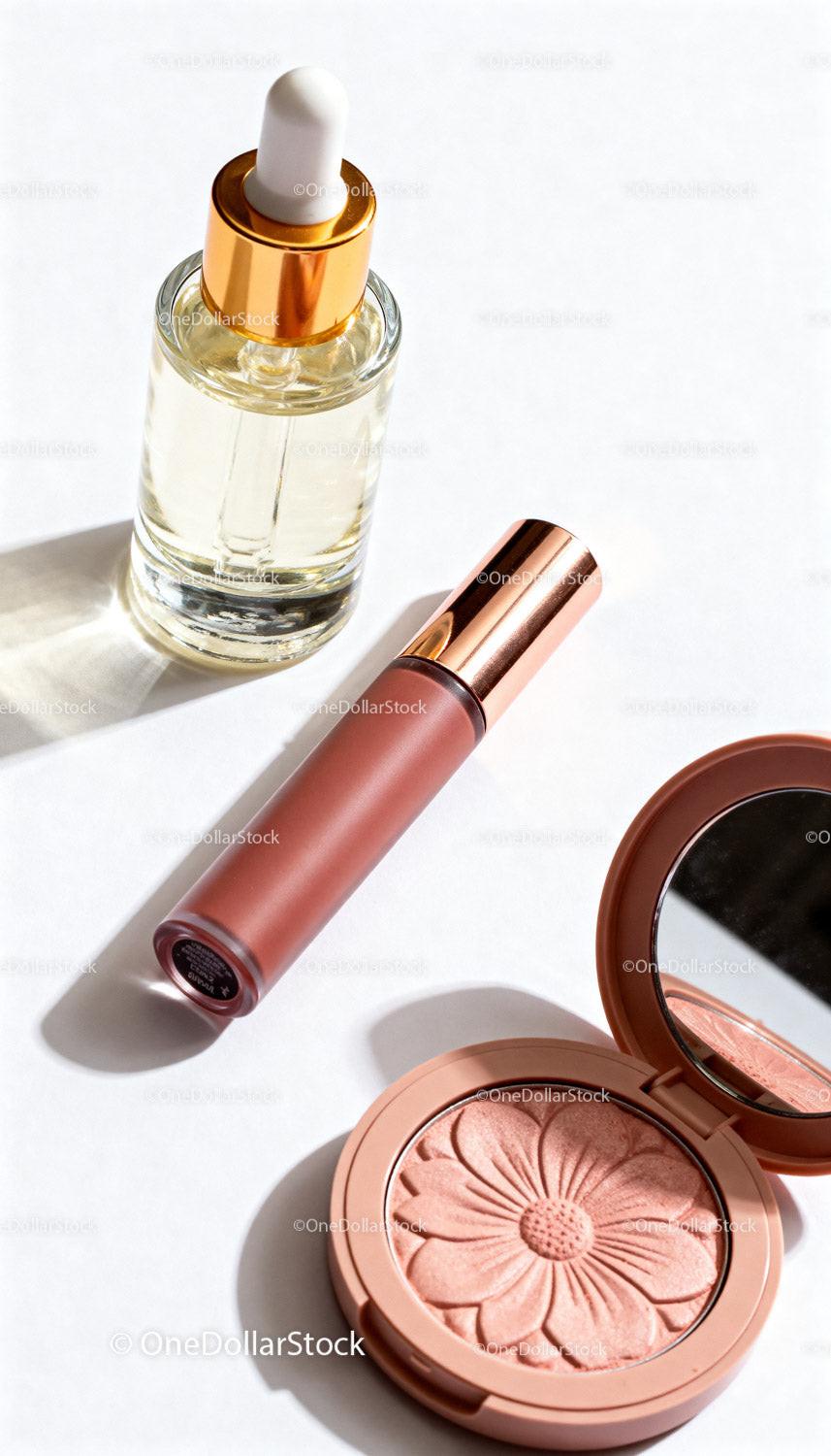 Elegant cosmetic essentials with blush and serum bottle