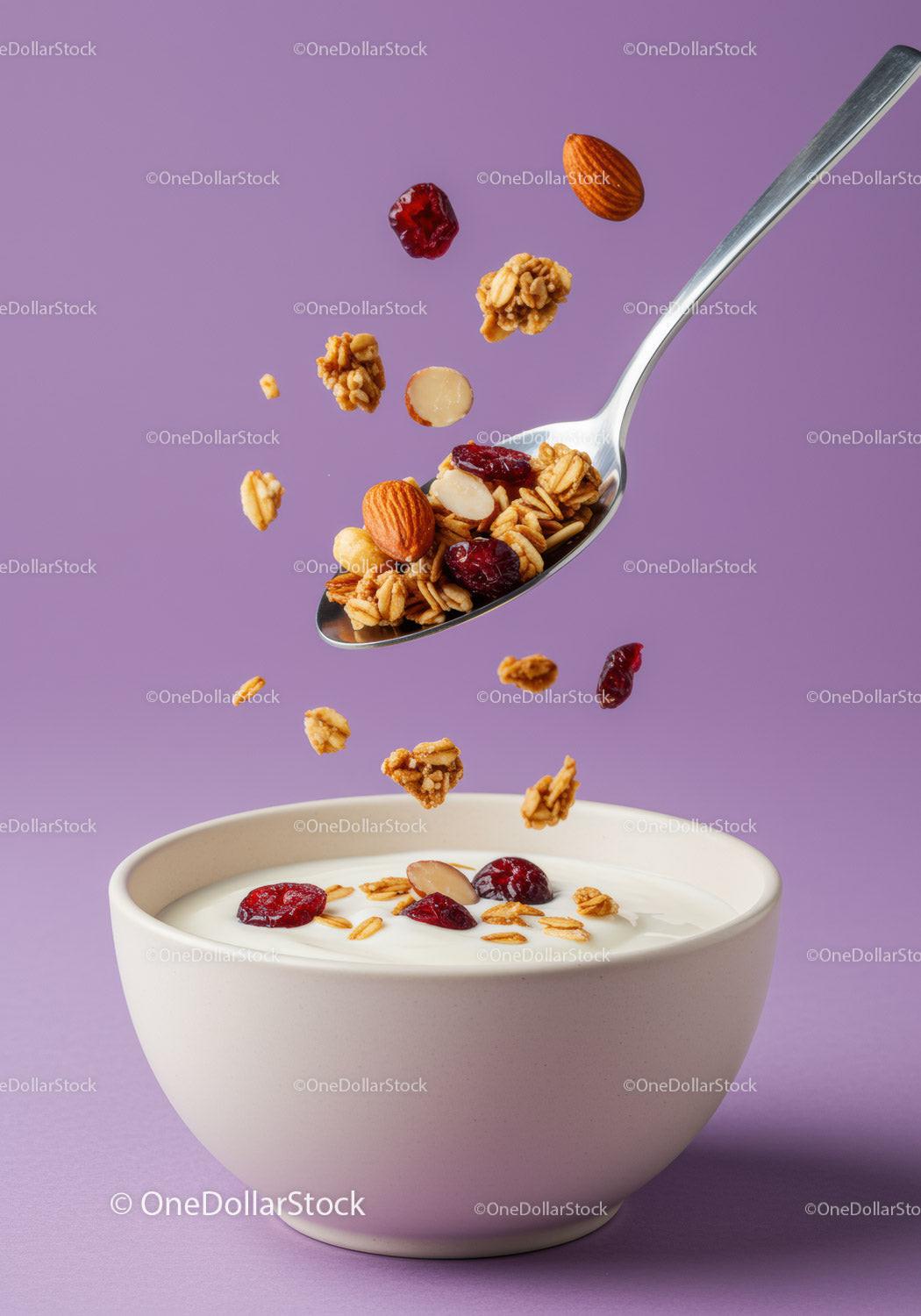 Healthy granola and nuts falling into white bowl