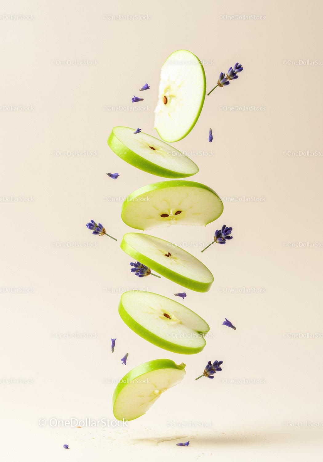 Floating slices of green apple with lavender flowers