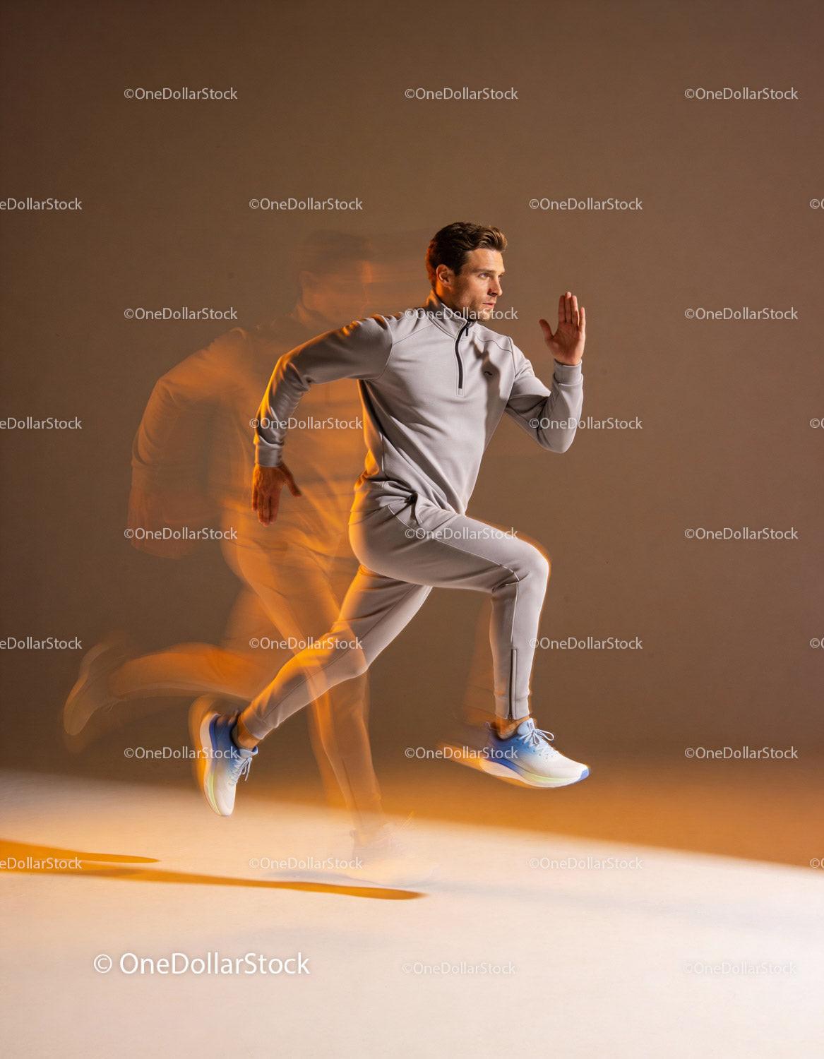 Athlete sprinting fast in gray sportswear with motion blur