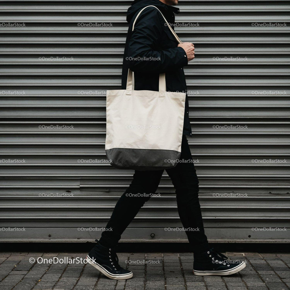 Person walking with white canvas tote bag on city street JPG Mockup Image preview