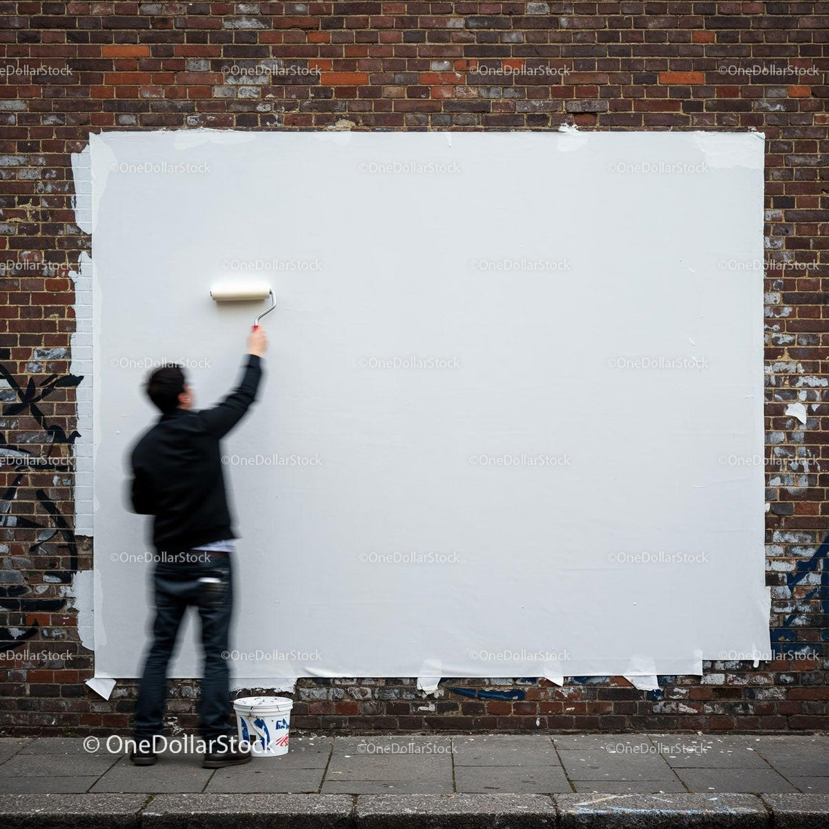 Man Painting Over Graffiti on Urban Brick Wall JPG Mockup Image preview