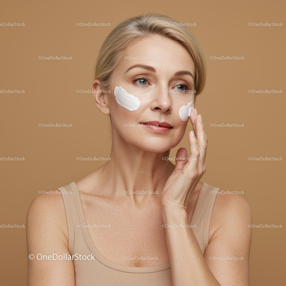 Elegant Mature Woman Applying Face Cream for Skincare Treatment
