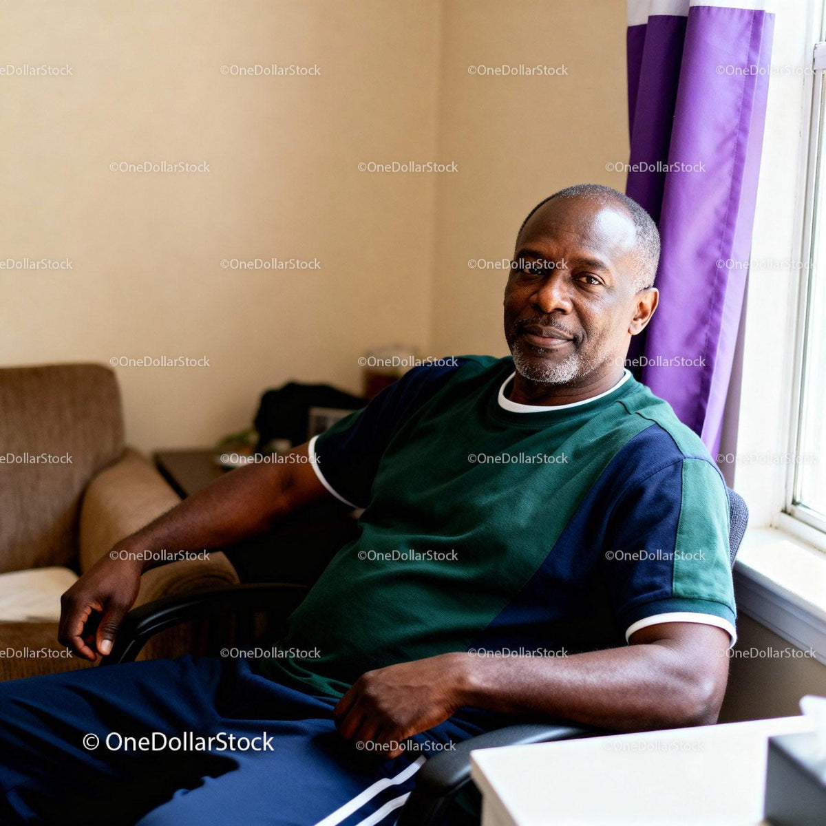 Middle-aged man relaxing at home near window light