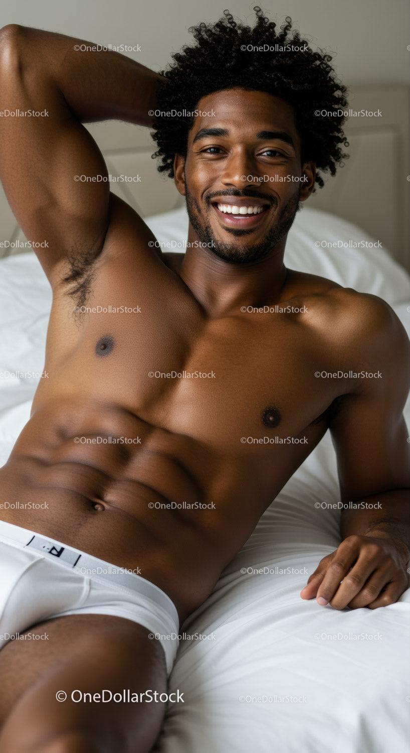 Relaxed young man smiling while lying on bed