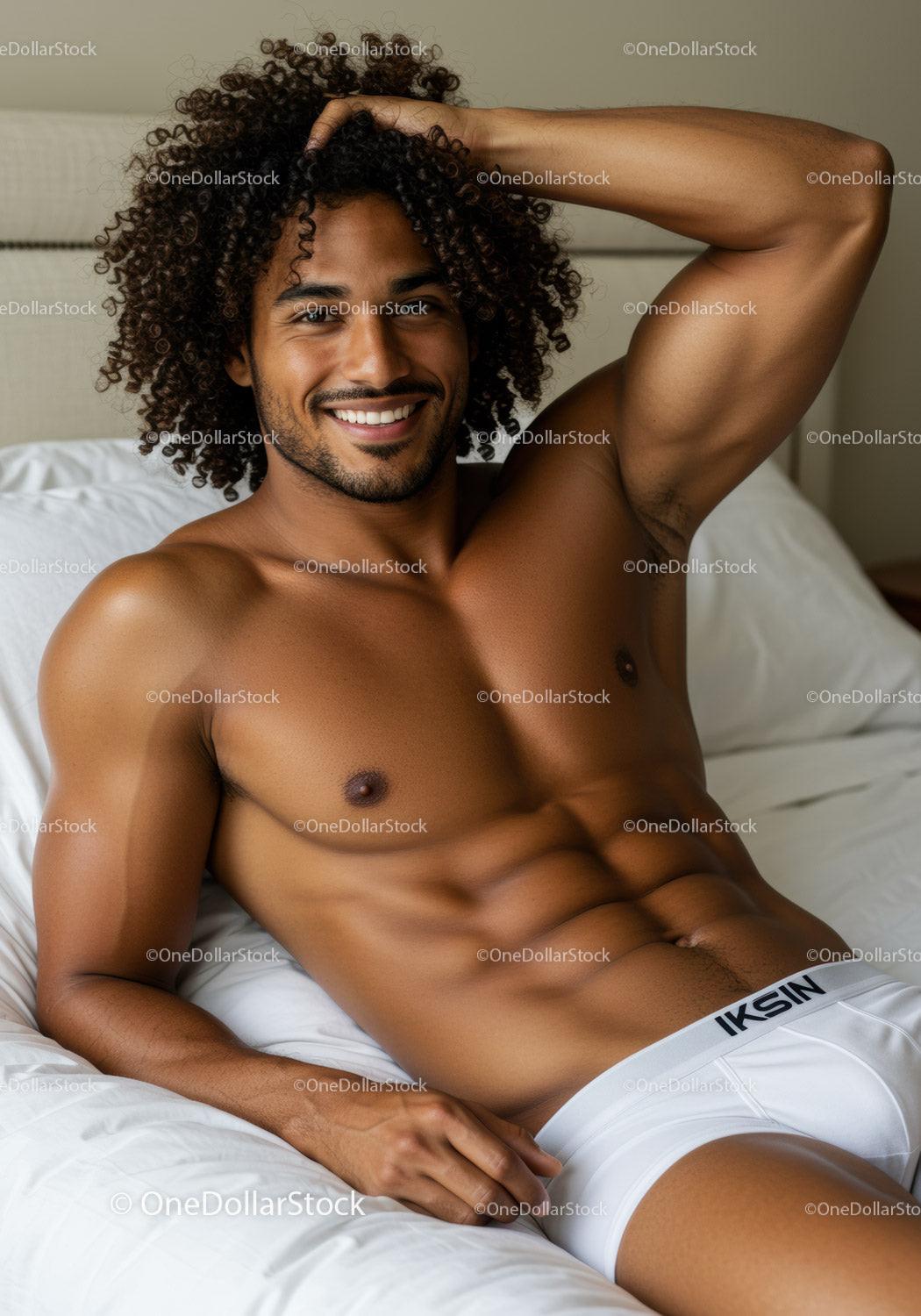 Smiling relaxed man posing shirtless on bed