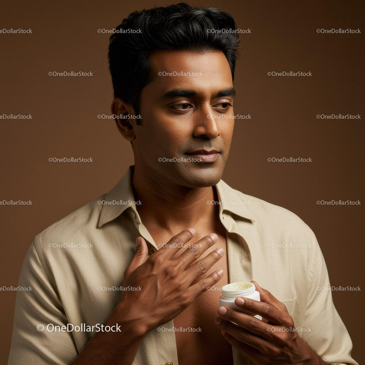 Young Man Applying Lotion for Skincare Routine in Studio