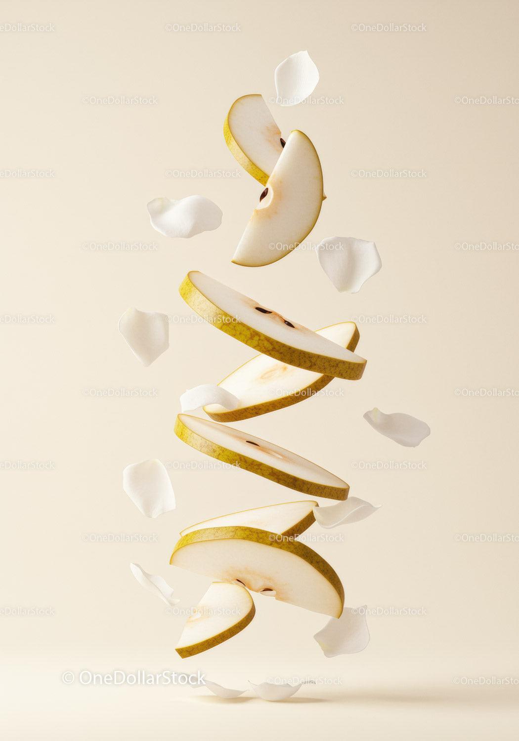 Floating slices of fresh pear with white petals