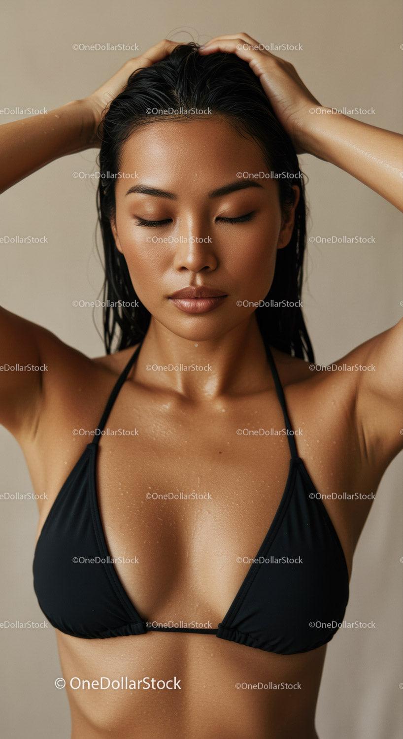 Beauty Woman with Wet Hair in Black Bikini Top Relaxing for Skincare