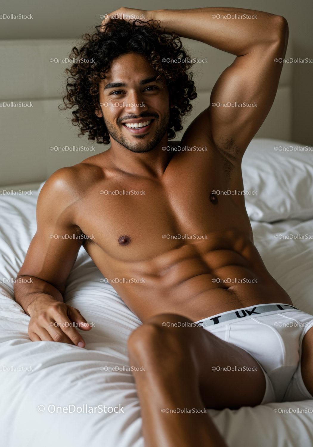 Smiling man relaxing shirtless on white bed