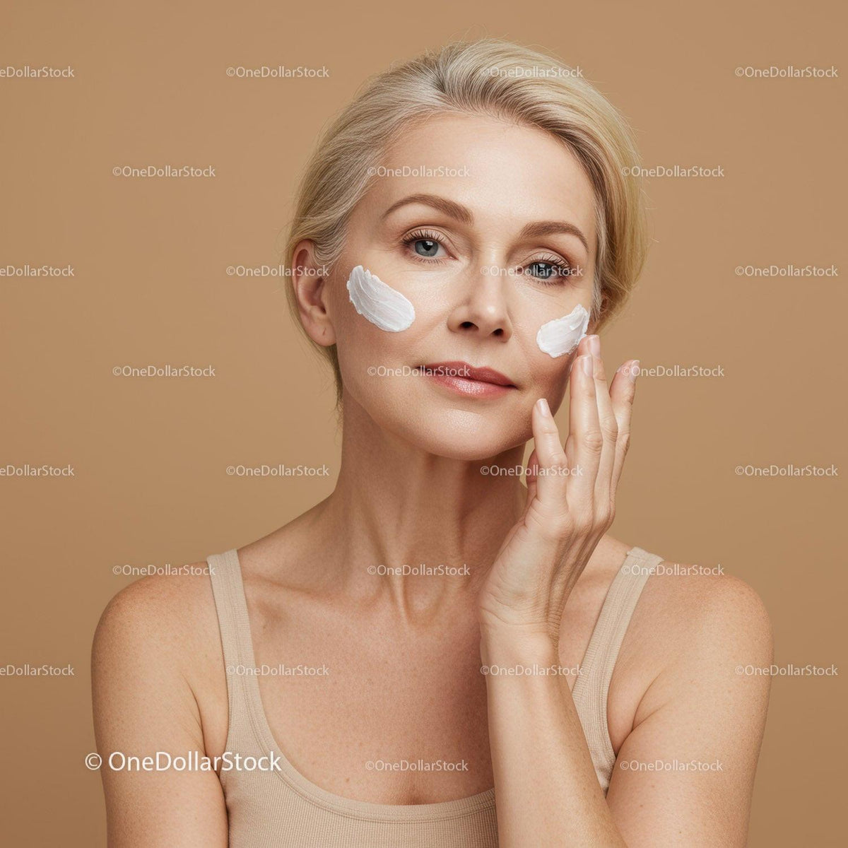 Elegant Mature Woman Applying Skin Care Cream for Facial Treatment