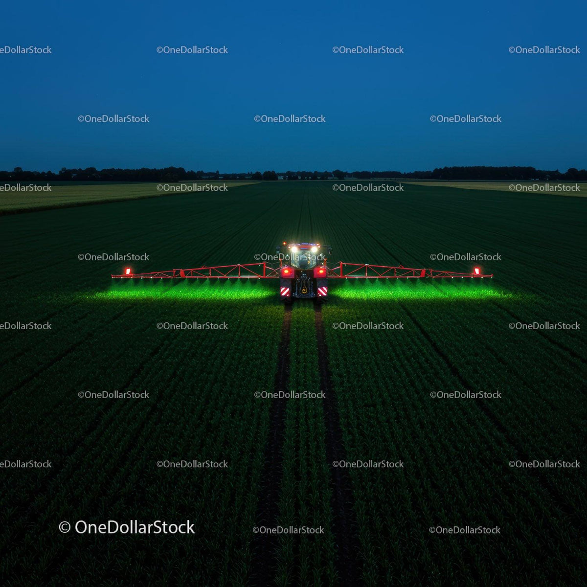 Farm vehicle operating in green fields at night