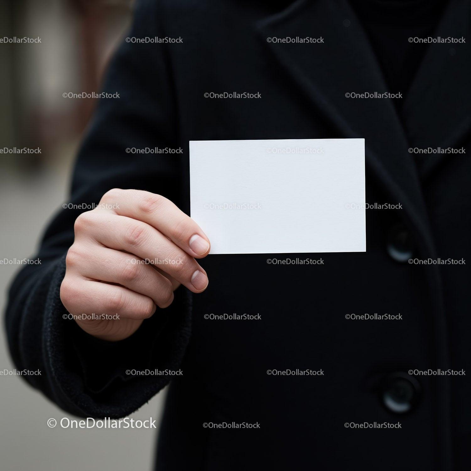 Person Holding Blank White Business Card in Black Coat