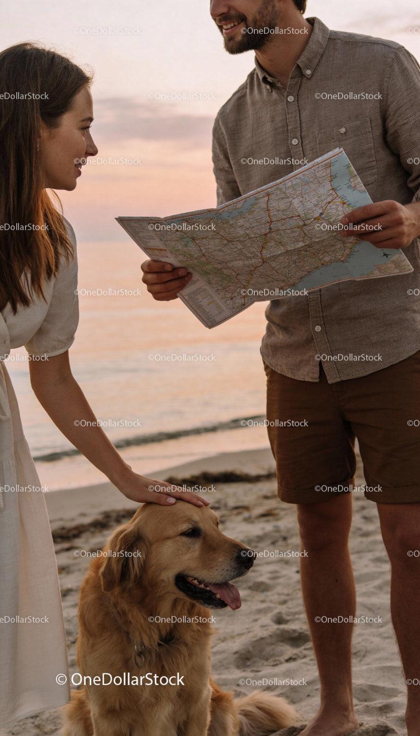 Couple with Golden Retriever Exploring Beach at Sunset