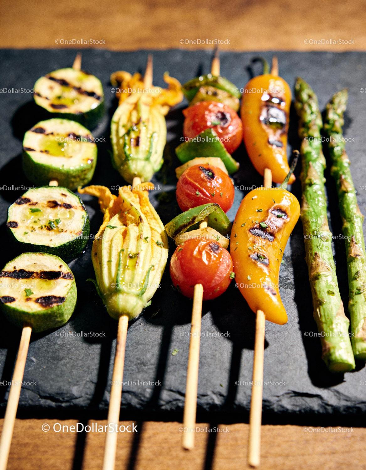 Grilled vegetable skewers with fresh herbs on slate