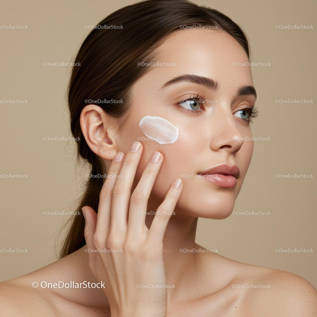 Portrait of a Young Woman Applying Face Cream for Skincare Routine