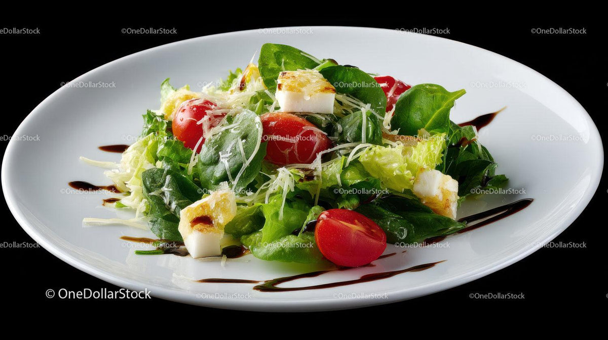 Fresh Green Salad with Cherry Tomatoes and Mozzarella on White Plate