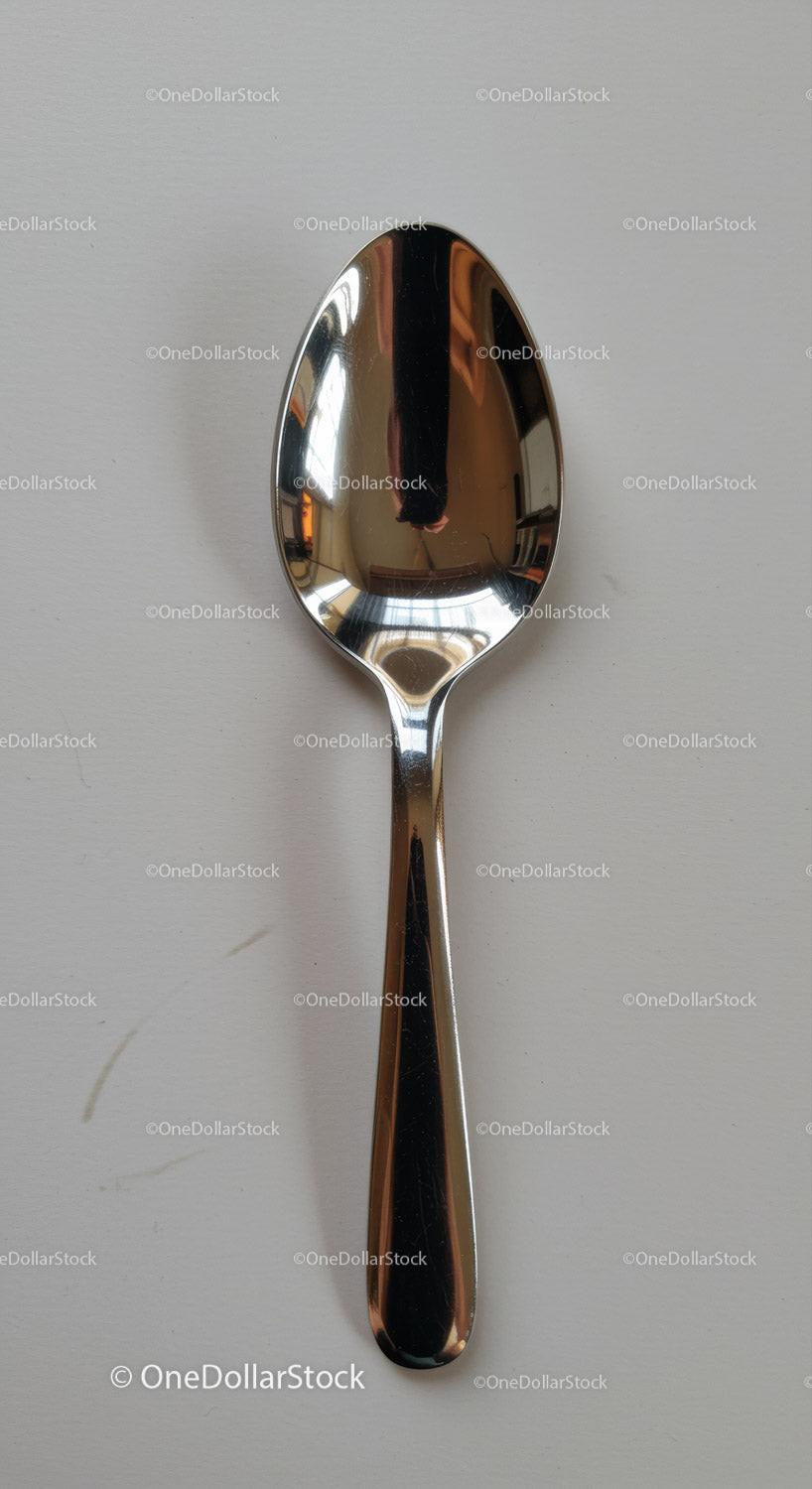 Simple stainless steel spoon on white surface