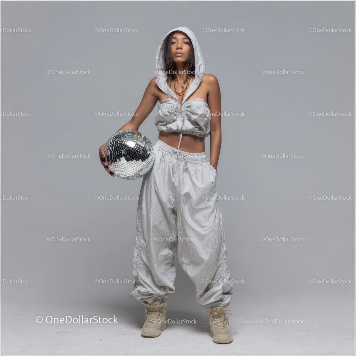 Stylish Woman in Metallic Outfit Holding Disco Ball for Modern Fashion Stock Photo Bundle preview 22