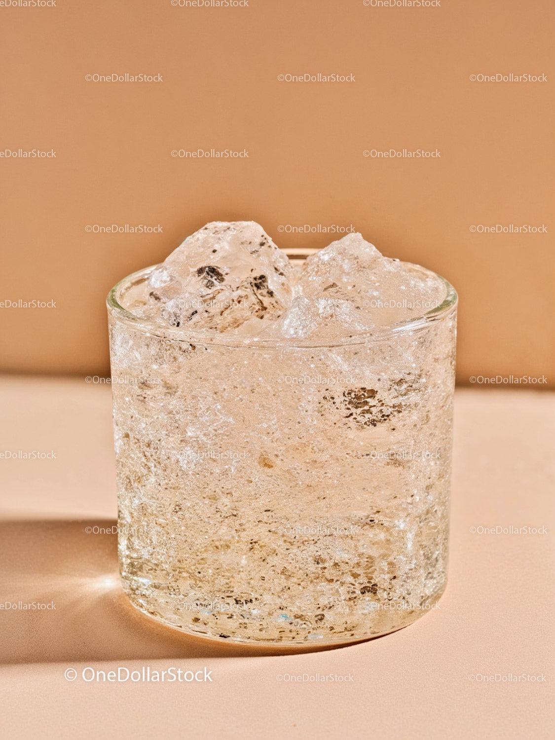 Close up of glass filled with sparkling water and ice cubes