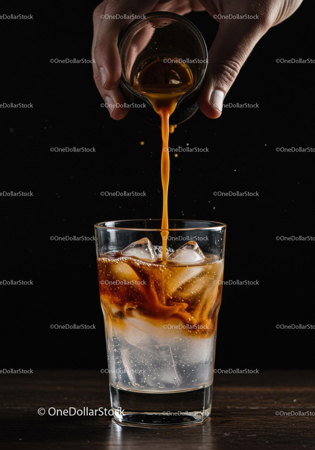 Pouring espresso over ice in a clear glass