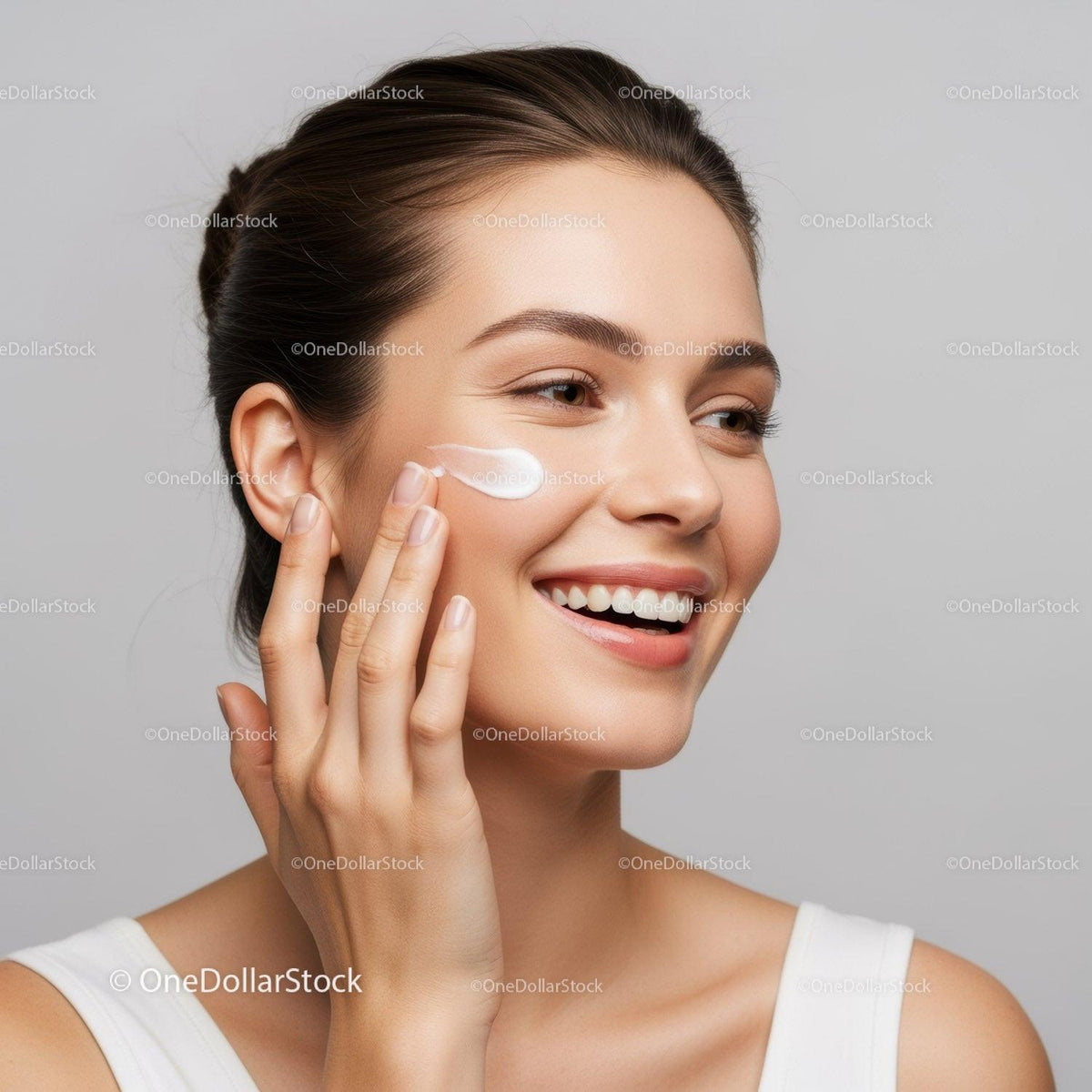 Woman Applying Facial Moisturizer for Healthy Glowing Skin