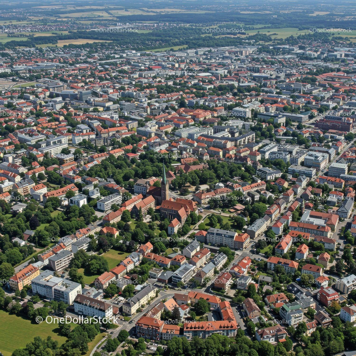 Aerial View of European City with Red Rooftops and Green Parks
