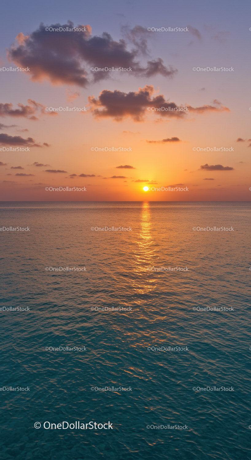 Serene Sunset over Calm Ocean with Colorful Sky and Clouds